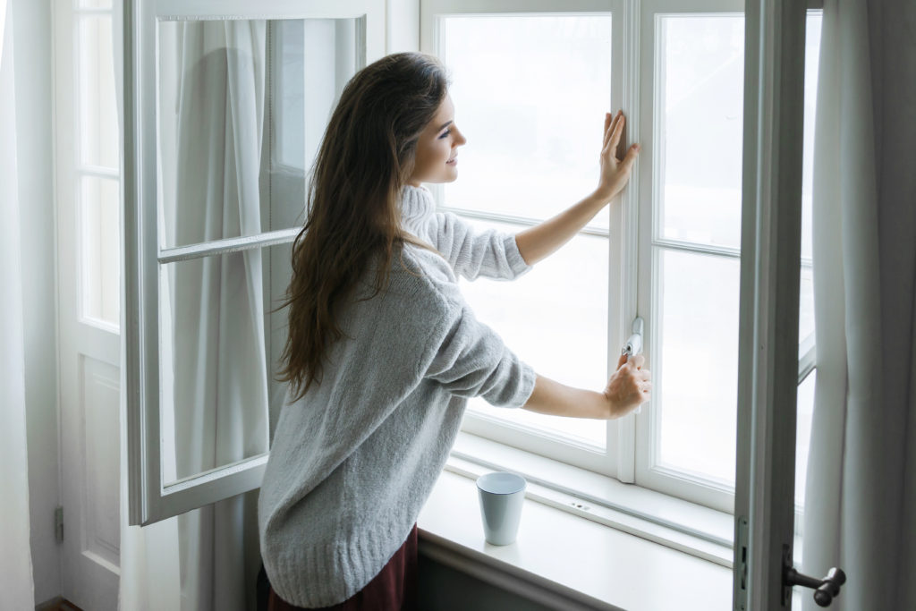 Woman opening windows